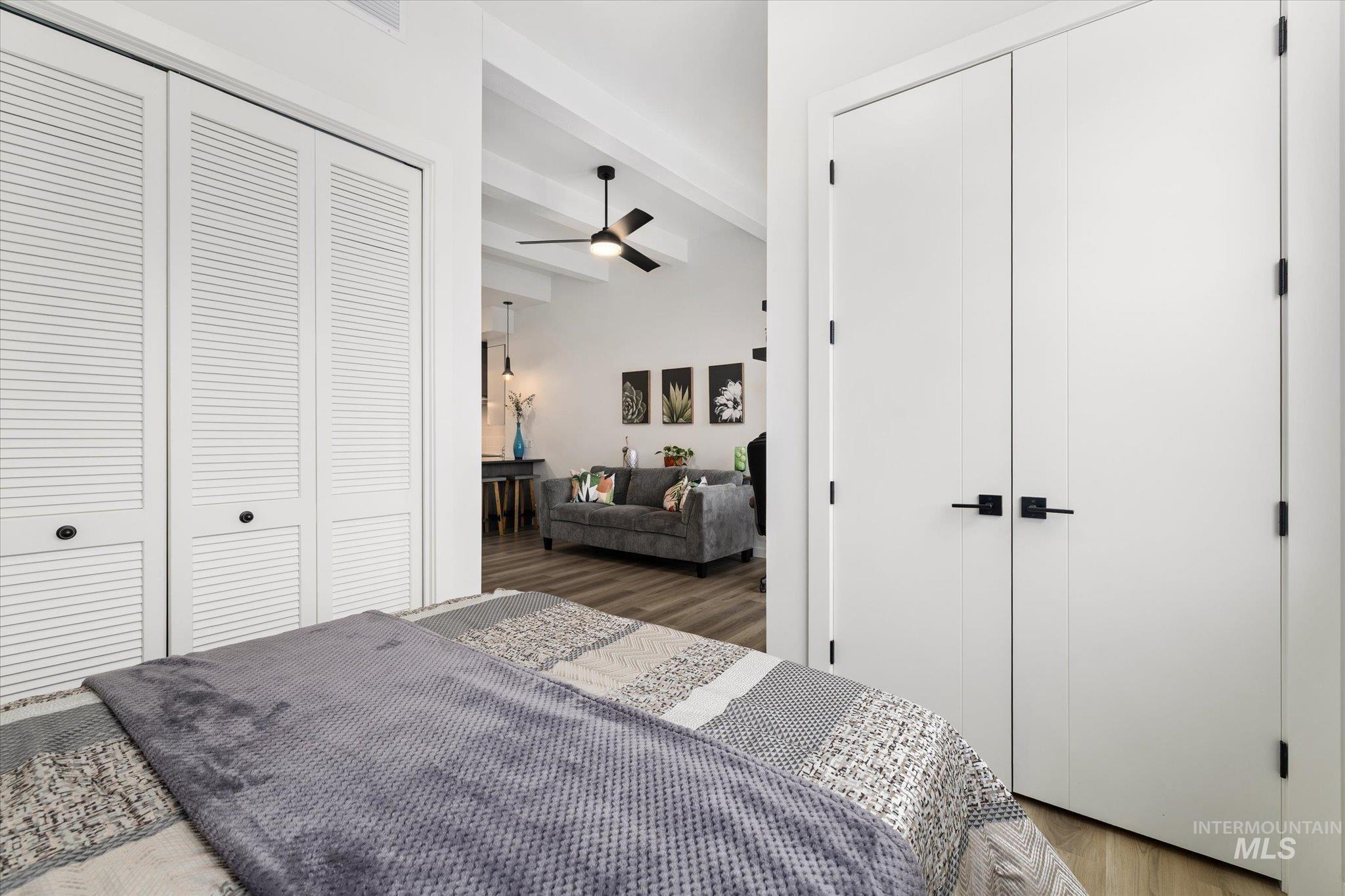 3850 East Haystack Street, Unit 302 Boise, ID 83716 - Photo 14 of 47 Bedroom with a closet, wood finished floors, and beamed ceiling