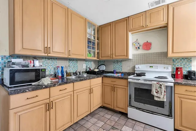 a kitchen with stainless steel appliances granite countertop a stove microwave and cabinets