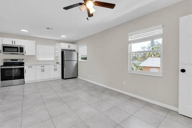 a view of a kitchen with a sink and dishwasher cabinets