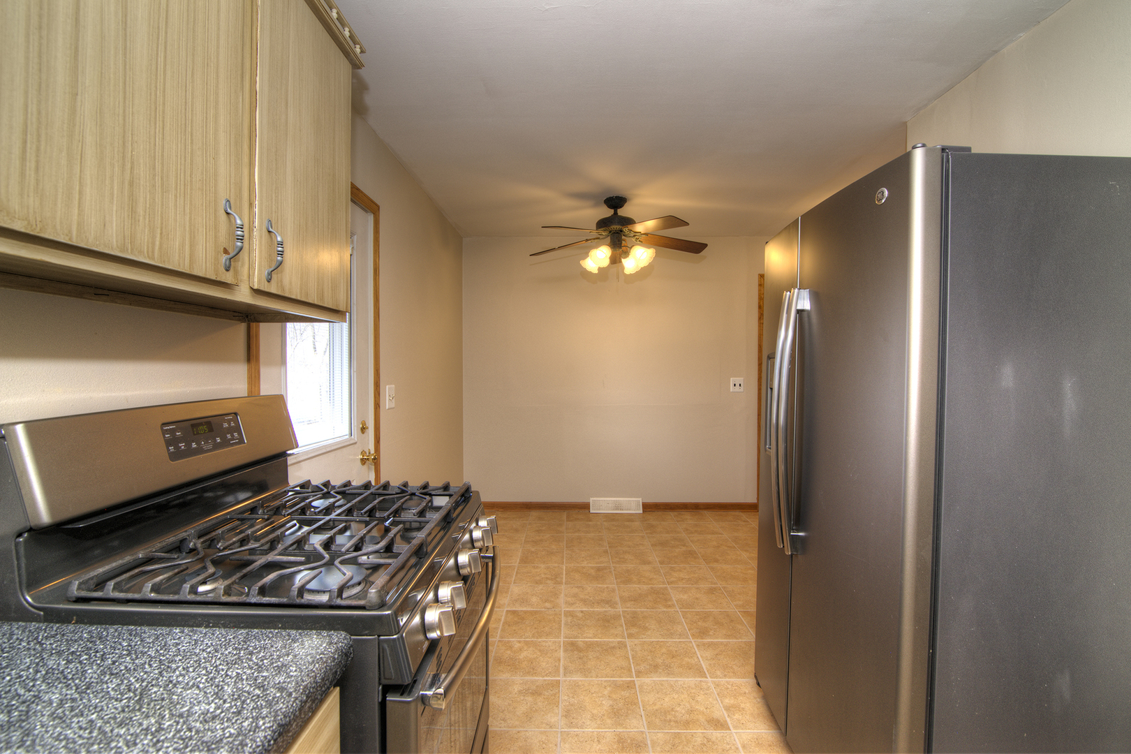 37 Durango Road Montgomery, IL 60538 - Photo 11 of 27 a kitchen with a stove and a refrigerator