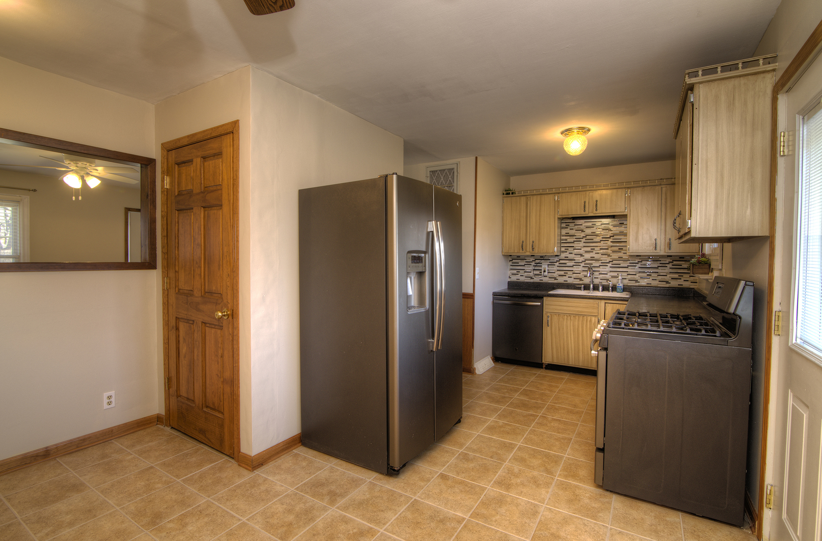 37 Durango Road Montgomery, IL 60538 - Photo 12 of 27 a kitchen with stainless steel appliances granite countertop a refrigerator and a stove