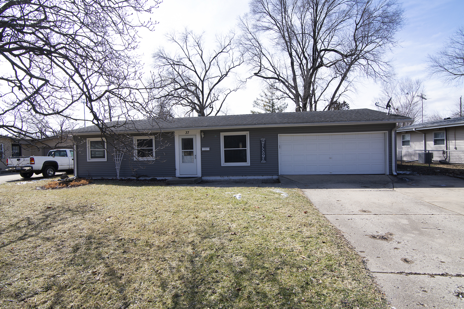 37 Durango Road Montgomery, IL 60538 - Photo 3 of 27 a front view of a house with a yard covered in snow