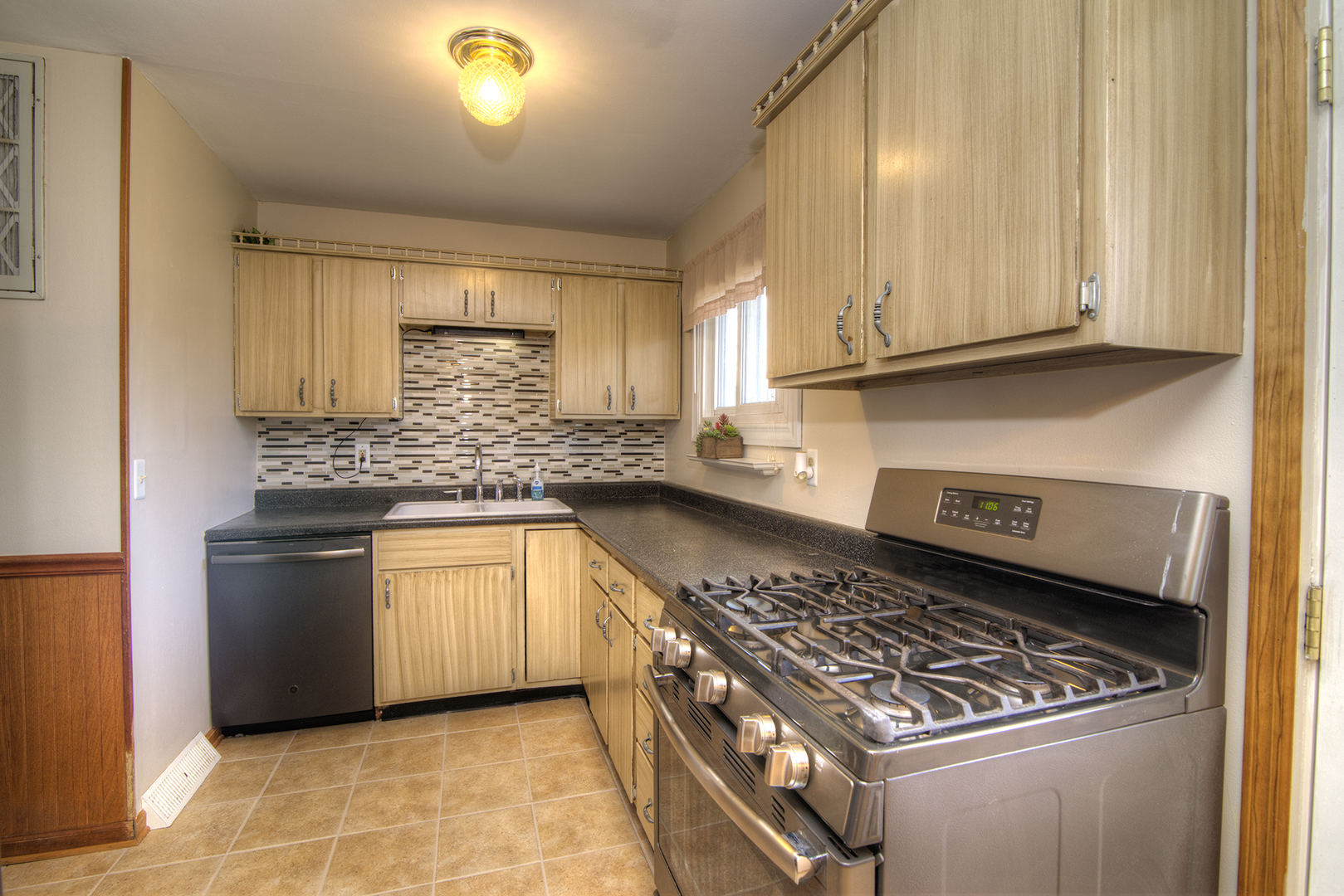 37 Durango Road Montgomery, IL 60538 - Photo 9 of 27 a kitchen with granite countertop a stove sink and cabinets