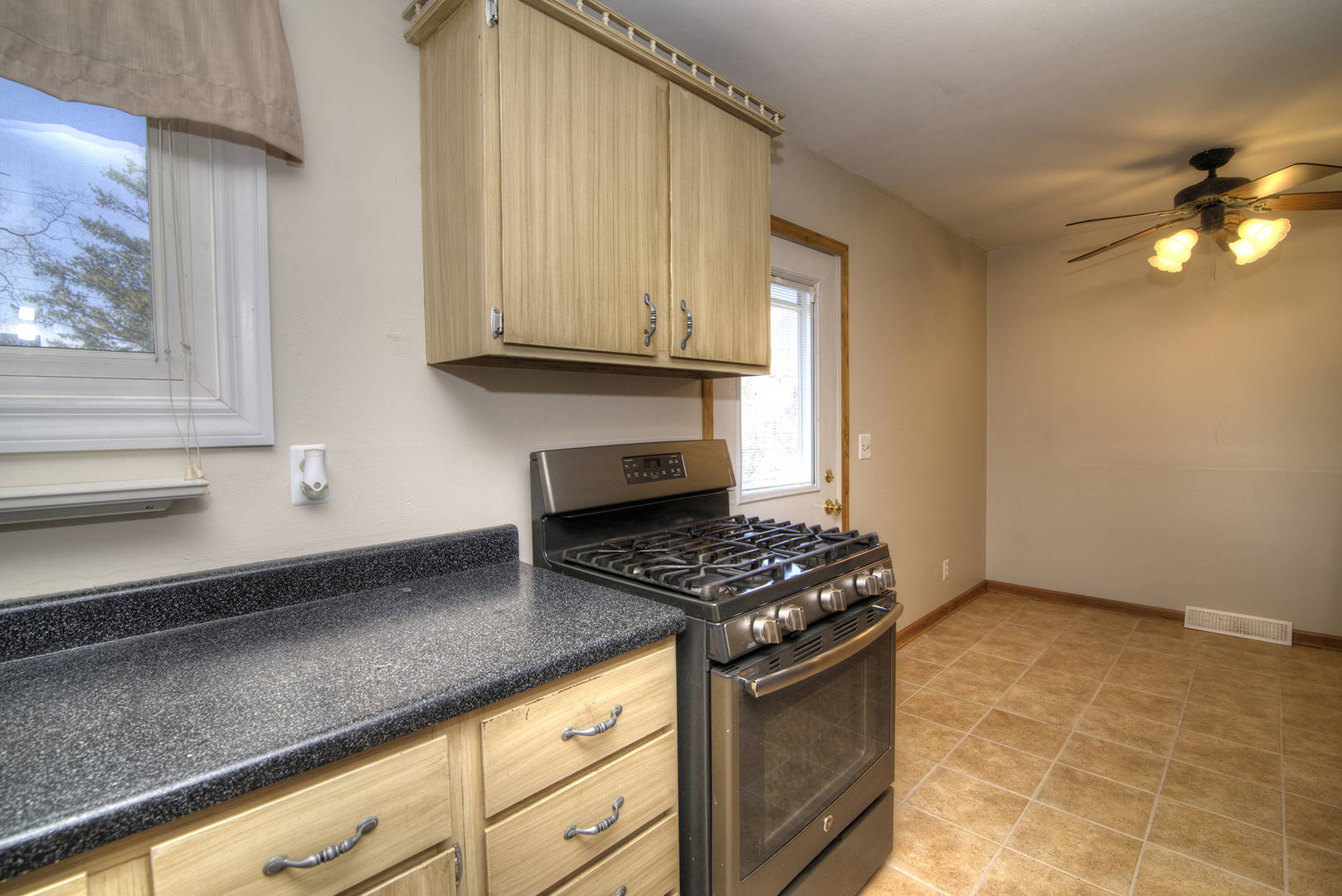37 Durango Road Montgomery, IL 60538 - Photo 10 of 27 a kitchen with granite countertop a stove a sink and a microwave