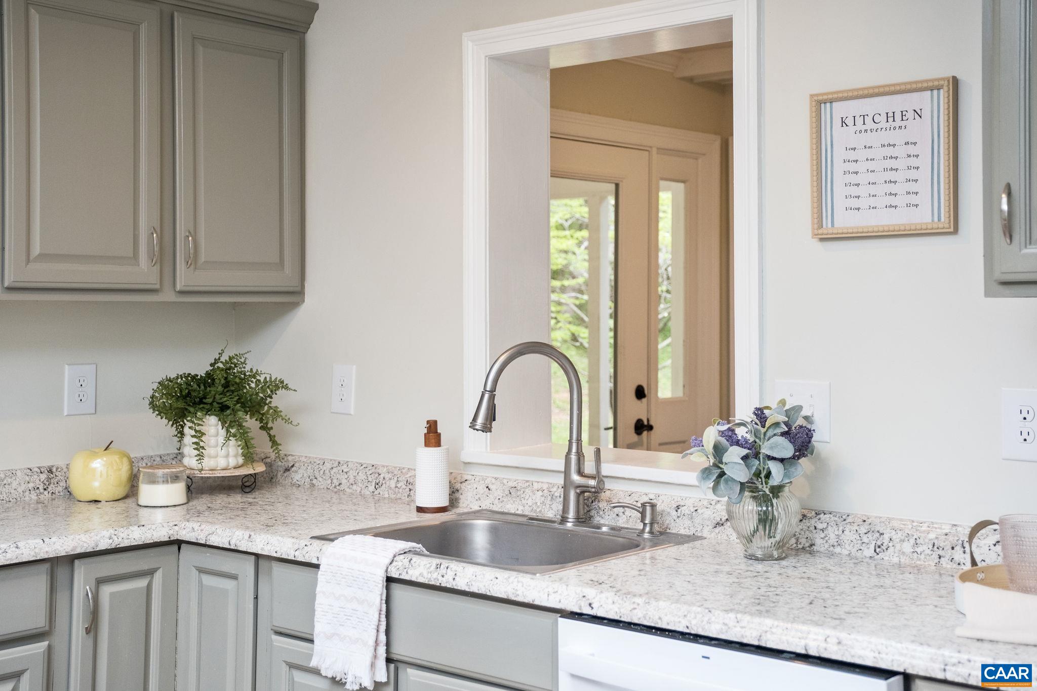 1680 Craigs Store Road Afton, VA 22920 - Photo 15 of 57 a kitchen with granite countertop a sink flowers and cabinets