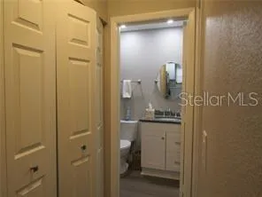 a bathroom with a granite countertop sink toilet and mirror