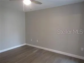 a view of an empty room with wooden floor