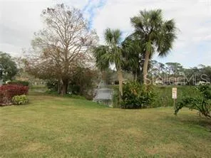 a view of a patio with table and chairs under an umbrella