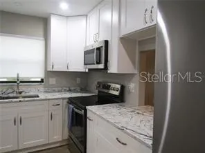 a kitchen with a sink stove and microwave