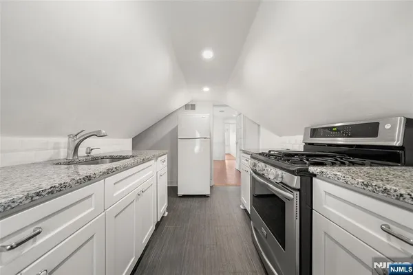 a kitchen with a stove top oven and sink