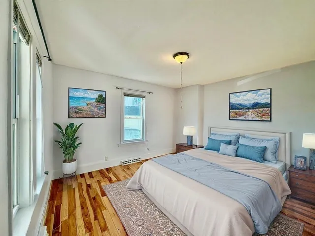 a bedroom with a large bed and a chandelier