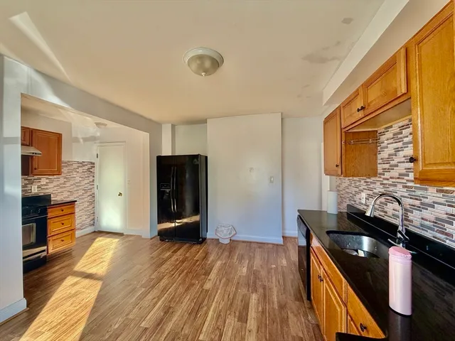 a kitchen with stainless steel appliances granite countertop a stove and a refrigerator