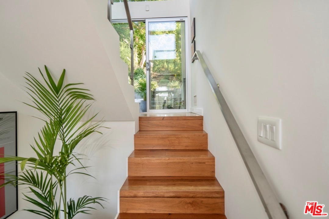3711 Prestwick Drive Los Angeles, CA 90027 - Photo 18 of 37 a view of staircase with wooden floor and a potted plant