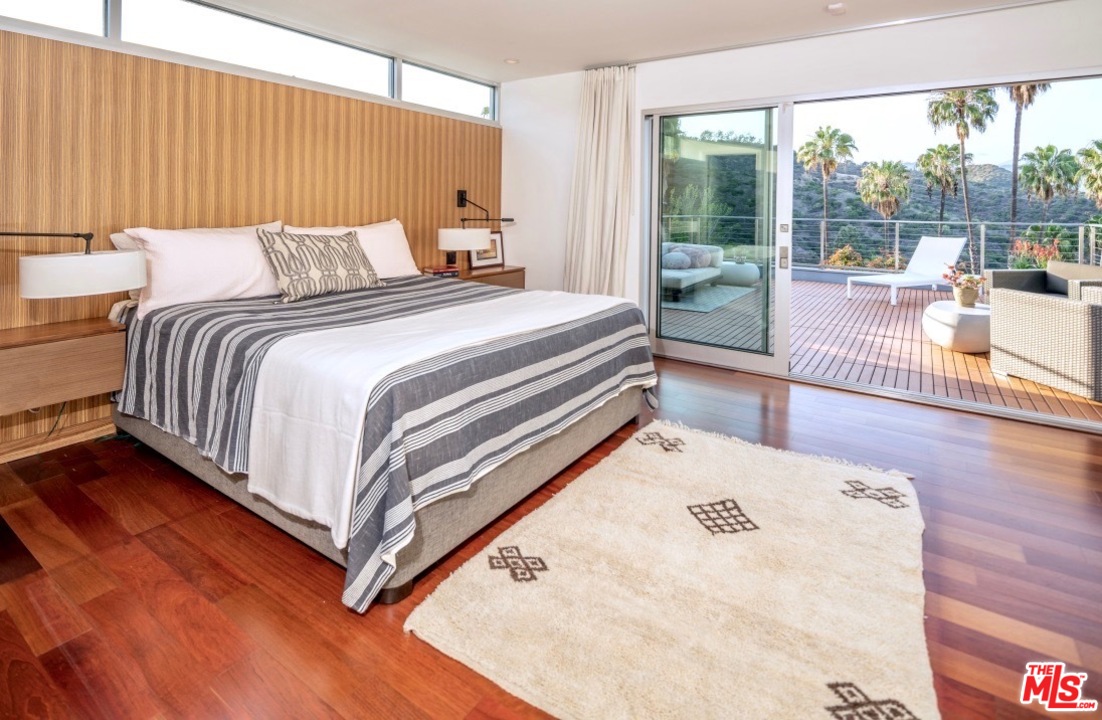 3711 Prestwick Drive Los Angeles, CA 90027 - Photo 20 of 37 a bed sitting in a spacious bedroom next to a large window