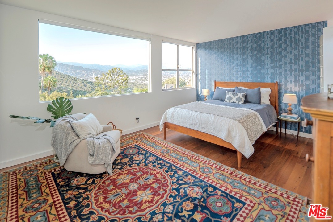 3711 Prestwick Drive Los Angeles, CA 90027 - Photo 25 of 37 a bedroom with a bed lamp and a large window with wooden floor