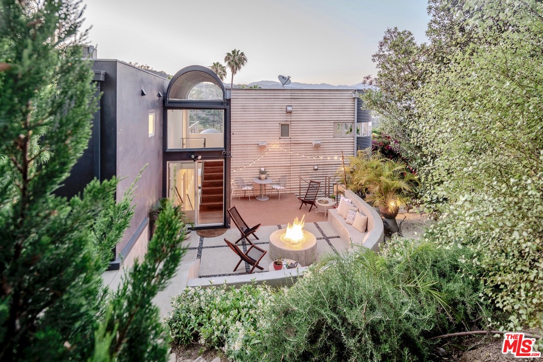 3711 Prestwick Drive Los Angeles, CA 90027 - Photo 31 of 37 a backyard of a house with table and chairs and potted plants