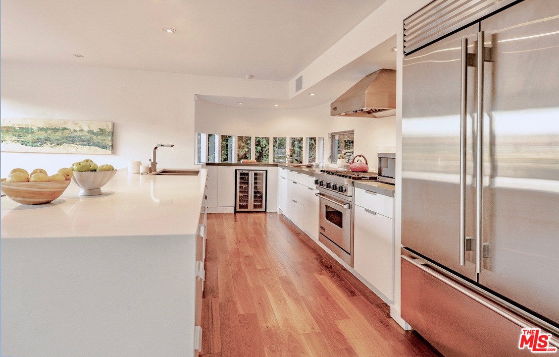 3711 Prestwick Drive Los Angeles, CA 90027 - Photo 7 of 37 a kitchen with stainless steel appliances a refrigerator a stove and wooden floor