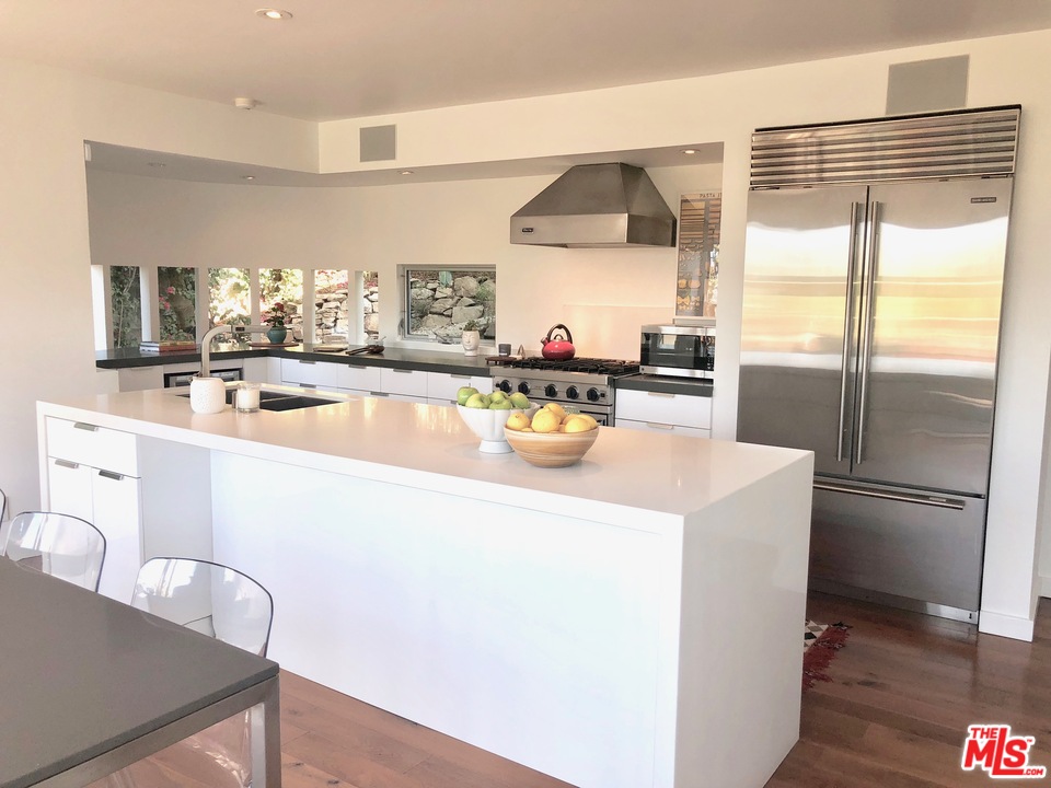 3711 Prestwick Drive Los Angeles, CA 90027 - Photo 10 of 37 a kitchen with a refrigerator a stove and a sink with wooden floor