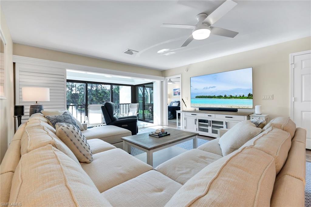 1672 Spoonbill Lane, Unit B Naples, FL 34105 - Photo 13 of 41 a living room with furniture and a flat screen tv