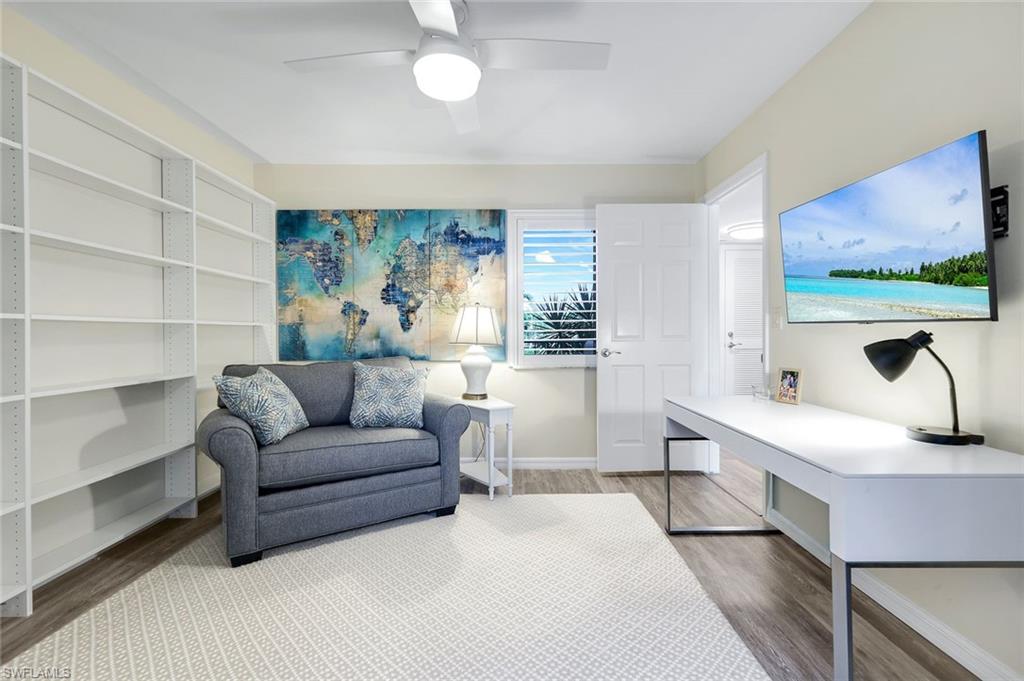 1672 Spoonbill Lane, Unit B Naples, FL 34105 - Photo 17 of 41 a living room with furniture and a flat screen tv