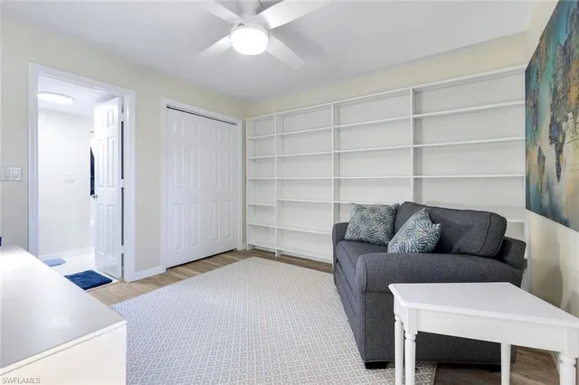 a living room with furniture and a ceiling fan