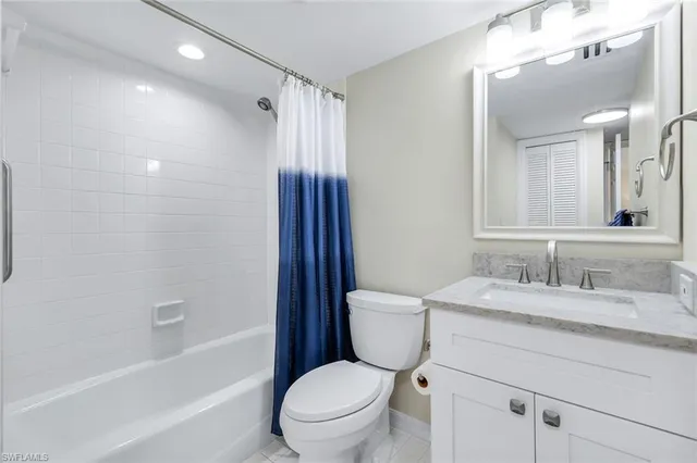 a bathroom with a granite countertop toilet sink and a mirror