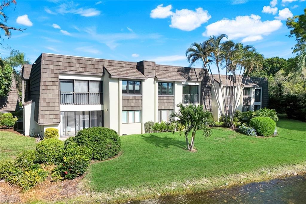 1672 Spoonbill Lane, Unit B Naples, FL 34105 - Photo 22 of 41 a view of a house with a yard