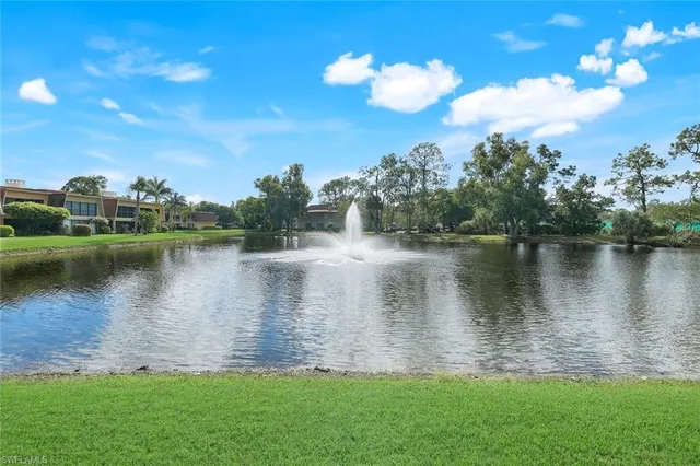 a view of a lake with houses in the back