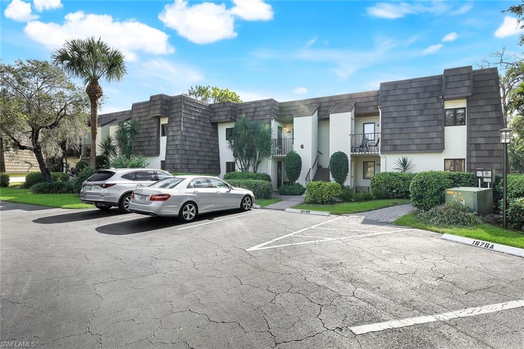 1672 Spoonbill Lane, Unit B Naples, FL 34105 - Photo 28 of 41 a car parked on the side of the road