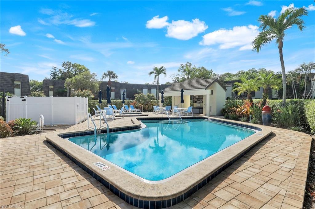 1672 Spoonbill Lane, Unit B Naples, FL 34105 - Photo 29 of 41 a view of a swimming pool with a patio