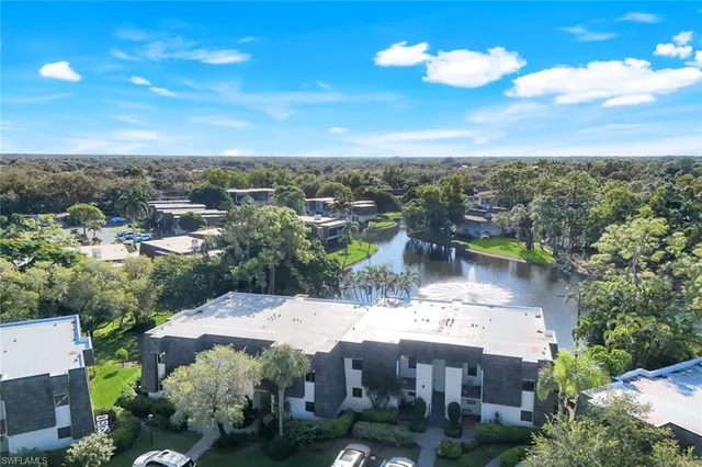 an aerial view of a house with a garden and swimming pool