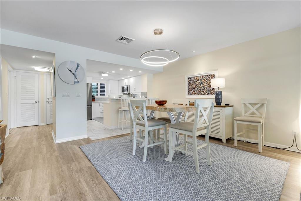 1672 Spoonbill Lane, Unit B Naples, FL 34105 - Photo 9 of 41 a living room with furniture and a wooden floor