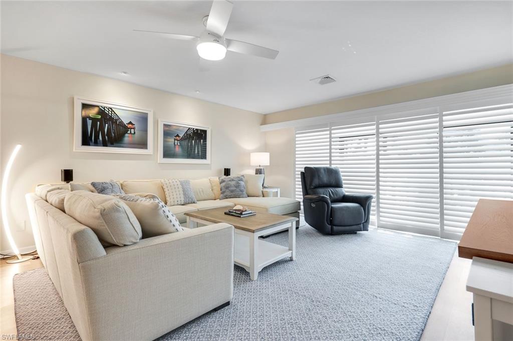 1672 Spoonbill Lane, Unit B Naples, FL 34105 - Photo 10 of 41 a living room with furniture and a large window