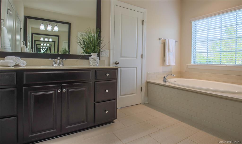 1026 Emory Lane Fort Mill, SC 29708 - Photo 17 of 41 a spacious bathroom with a granite countertop sink a mirror and a bathtub