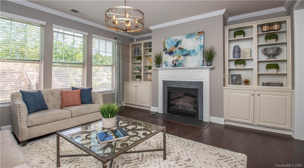 1026 Emory Lane Fort Mill, SC 29708 - Photo 10 of 41 a living room with furniture a chandelier and a fireplace