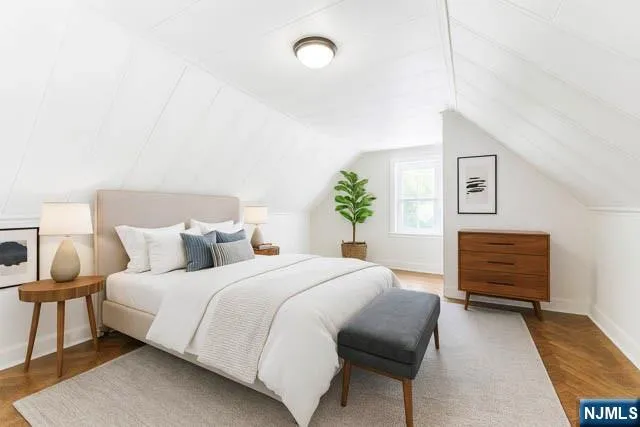 a room with a table chairs and refrigerator