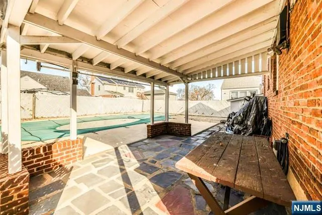 a view of a porch with wooden floor and furniture