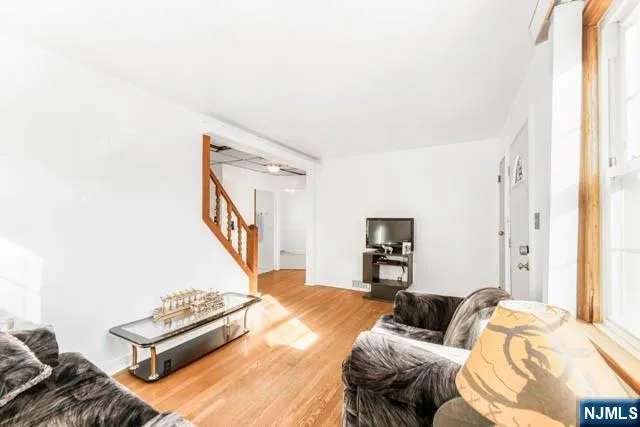 a view of a livingroom with furniture and staircase