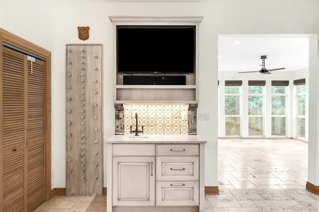 a view of an empty room with a fireplace and a flat screen tv