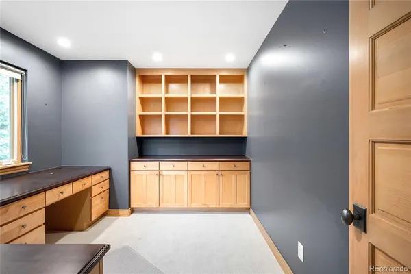 a kitchen with granite countertop a sink and a refrigerator