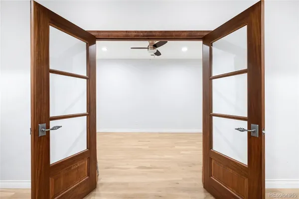 a view of a livingroom with wooden floor and a flat screen tv