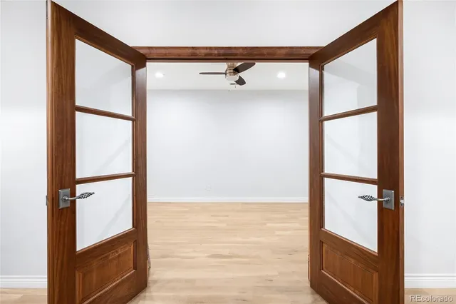a view of a livingroom with wooden floor and a flat screen tv