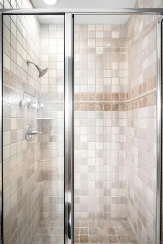 a view of a patio with table and chairs under an umbrella