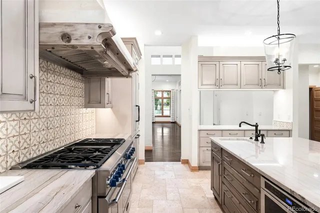 a kitchen with granite countertop a sink and a stove