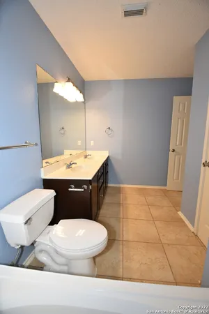 a bathroom with a sink a toilet and mirror