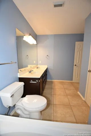 a bathroom with a sink a toilet and mirror