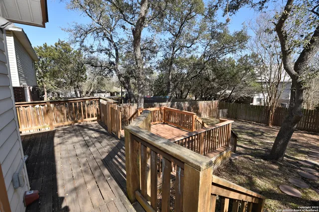 a view of balcony with wooden floor and fence