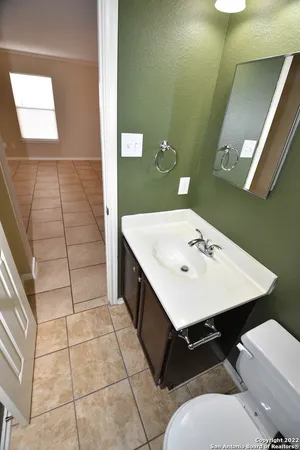 a view of a bathroom with a sink a toilet and a mirror