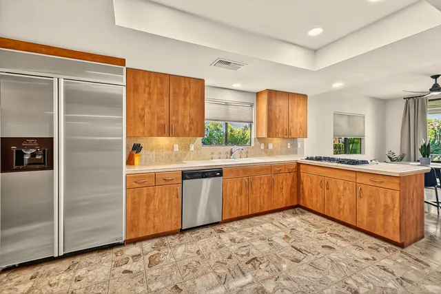 a kitchen with stainless steel appliances granite countertop a refrigerator and sink