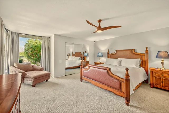 a spacious bedroom with a bed and a couch